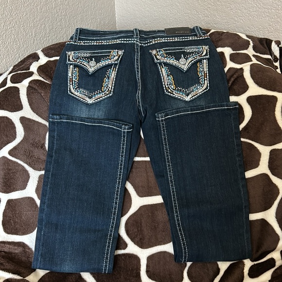 Grace jeans with blue brown and sliver trim around the pockets. - Picture 2 of 4